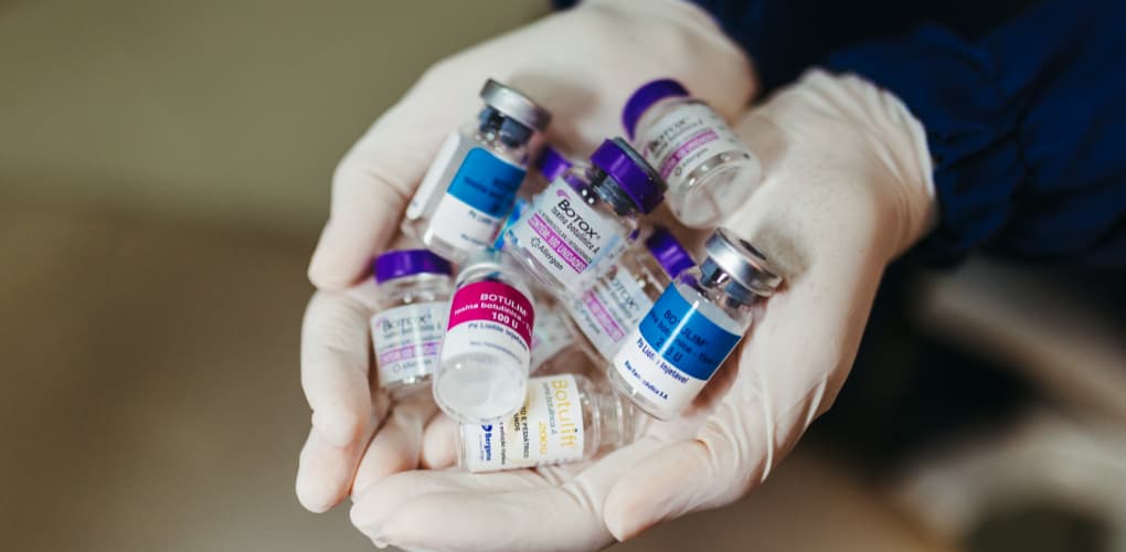 case study of botox in dentistry; provider holds bottles of botox