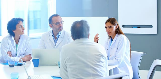 photo of physicians sitting at table