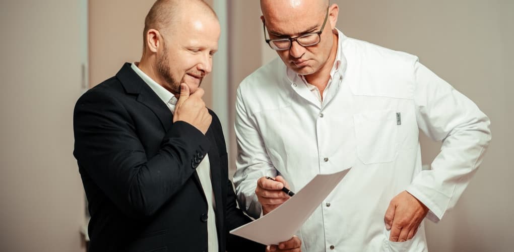 physician and patient looking at results, depicting communicating patient test results